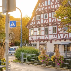 Half-timbered house in autumn surroundings with street lighting and flowers Half-timbered house in autumn surroundings with street lighting and flowers