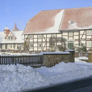 Half-timbered house, church tower