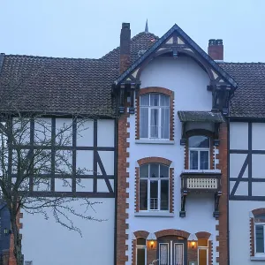 Half-timbered House and St Nicolai Church, Alfeld Print
