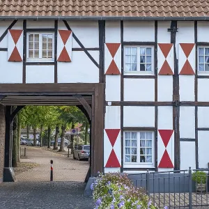 A half-timbered house with red brick detail and a large archway A half-timbered house with red brick detail and a large archway