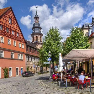 Half-timbered house with street cafe and hospital church in the old town