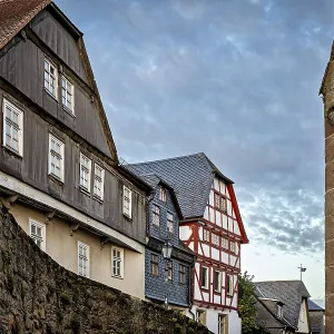 Half-timbered houses and city walls in a cozy evening mood Half-timbered houses and city walls in a cozy evening mood