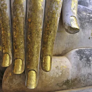 Hand of a Buddha statue decorated with gold leaf (Bhumispara-mudra: Buddha Gautama at the moment of enlightenment)