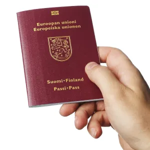 A Hand holding a new biometric Finnish passport