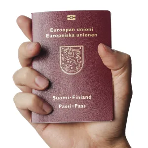 Hand holding a new biometric Finnish passport Hand holding a new biometric Finnish passport
