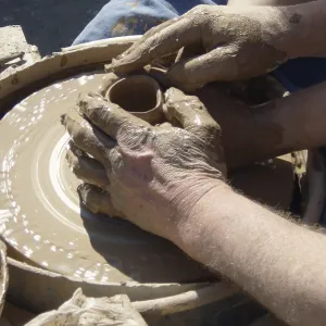Hands of master potter and apprentice on potter's wheel<br> Hands of master potter and apprentice on potter's wheel