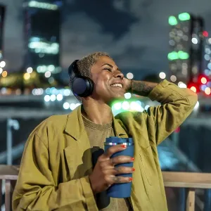 Happy Black Woman Relaxing in City at Night Print