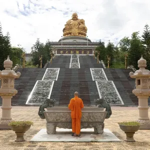 Happy Buddha, monk at an altar Happy Buddha, monk at an altar