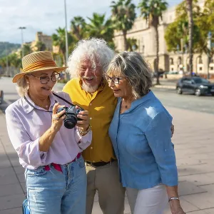 Three happy senior friends are standing on a city street Three happy senior friends are standing on a city street