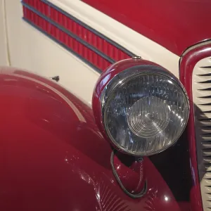 Headlights and bonnet of a red classic car