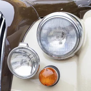 Headlights, indicators and radiator grille of a British sports car from the seventies Headlights, indicators and radiator grille of a British sports car from the seventies