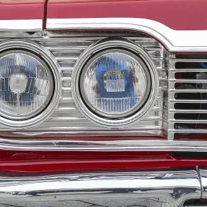 Headlights and radiator grille of an American saloon car from the sixties Headlights and radiator grille of an American saloon car from the sixties