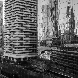 High-rise buildings and distorted reflections on glass in a monochrome setting in Toronto High-rise buildings and distorted reflections on glass in a monochrome setting in Toronto