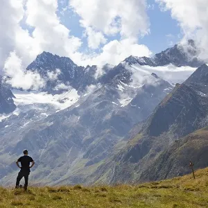 Hiker looking into the mountain massif of the Oetztal Alps in the rear Passeier Valley Hiker looking into the mountain massif of the Oetztal Alps in the rear Passeier Valley