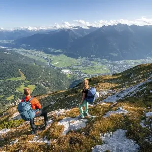 Hikers descending, Inn valley and mountain landscape Hikers descending, Inn valley and mountain landscape