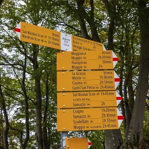 Hiking Sign Board with Distance and Direction in the Mountain in Monte Generoso Hiking Sign Board with Distance and Direction in the Mountain in Monte Generoso