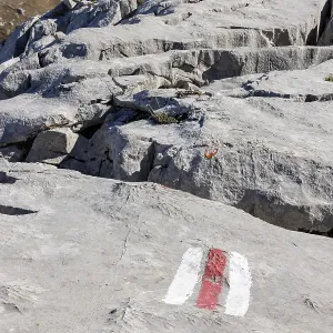 Hiking trail marking, trail sign on limestone