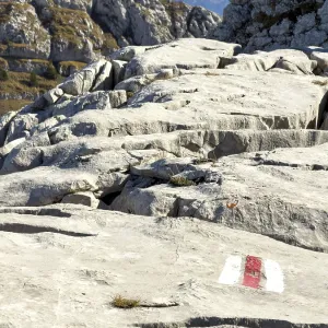 Hiking trail marking, trail sign on limestone