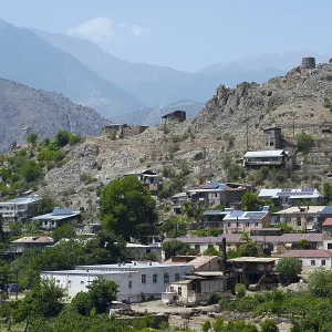 Hilly landscape with a village using solar panels