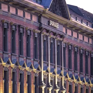 Historic building with brick facade and classic architecture in sunlight Historic building with brick facade and classic architecture in sunlight