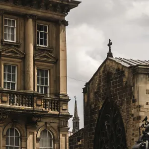 Historic building next to church with intricate stonework under a partly cloudy sky in Newcastle Upon Tyne Historic building next to church with intricate stonework under a partly cloudy sky in Newcastle Upon Tyne