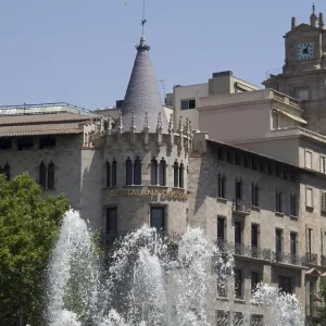 Historic building with a clock tower and impressive Gothic architecture in front of a fountain Historic building with a clock tower and impressive Gothic architecture in front of a fountain