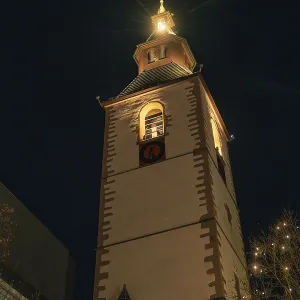 Historic church tower brightly lit at night Historic church tower brightly lit at night