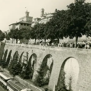 Historic city wall with tourists and historic buses