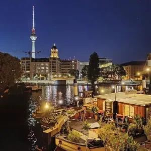 Historic harbour with museum ships and television tower in the blue hour