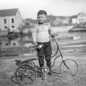 Historic photograph, child with a tricycle Historic photograph, child with a tricycle