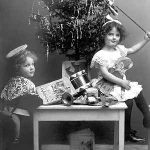 Historic photograph, children beneath a Christmas tree Historic photograph, children beneath a Christmas tree