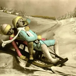 Historic photograph, two children riding a sled