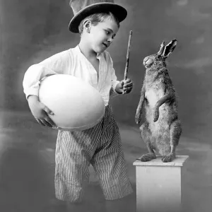 Historic photograph, Easter, boy with a huge egg and a hare Historic photograph, Easter, boy with a huge egg and a hare