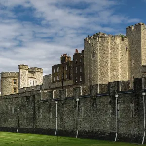 Historic stone structure under a vibrant blue sky with clouds at The Tower of London