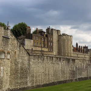 Historic stone walls of a fortification under a cloudy sky at The Tower of London