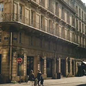 Historic street scene with pedestrians and a gilded building facade
