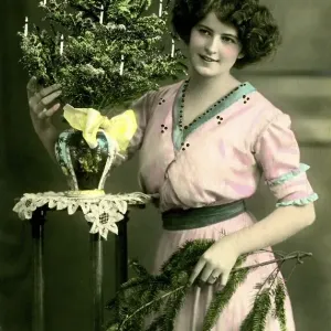 Historical photo, woman with Christmas tree Historical photo, woman with Christmas tree