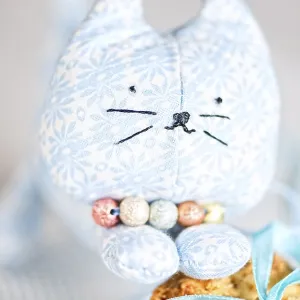 Homemade puppet, a cat and cookie on tablecloth Homemade puppet, a cat and cookie on tablecloth