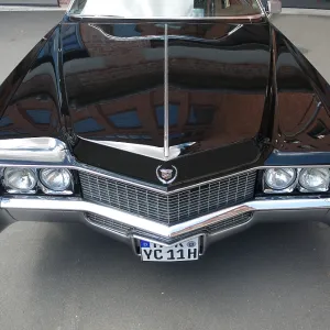 Hood of an American Cadillac with the reflection of a building Hood of an American Cadillac with the reflection of a building