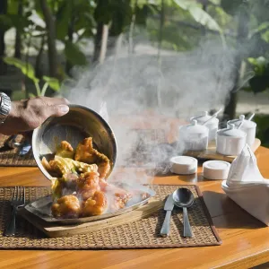 A hot plate with Thai food being served A hot plate with Thai food being served
