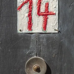 House number sign number fourteen and old doorbell on a half-timbered house in the old town centre House number sign number fourteen and old doorbell on a half-timbered house in the old town centre