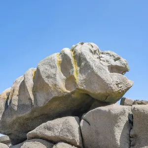 A huge granite rock formed by erosion in shades of pink to grey-brown A huge granite rock formed by erosion in shades of pink to grey-brown