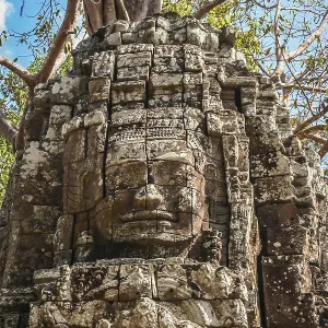 Huge stone face form in the Bayon Temple in the Angkor temple complex near Siem Reap Huge stone face form in the Bayon Temple in the Angkor temple complex near Siem Reap
