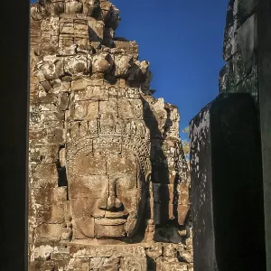 Huge stone face sculpture in the Bayon Temple in the Angkor temple complex near Siem Reap Huge stone face sculpture in the Bayon Temple in the Angkor temple complex near Siem Reap