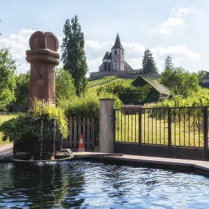Hunawihr saint hune fountain and old fortified church surrounded by vineyards Hunawihr saint hune fountain and old fortified church surrounded by vineyards