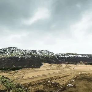 Iceland landscape in cloudy weather with fields and mountains Iceland landscape in cloudy weather with fields and mountains