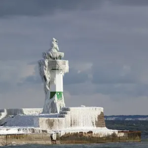 Icy lighthouse in harbour, Baltic Sea