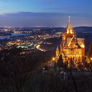 Illuminated Drachenburg Castle above the Rhine Valley in the evening