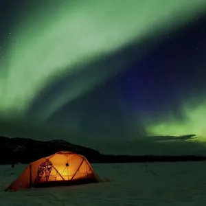 Illuminated expedition tent and traditional wooden snow shoes