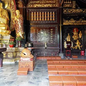 Impressive interior with Buddhist statues and red details Impressive interior with Buddhist statues and red details